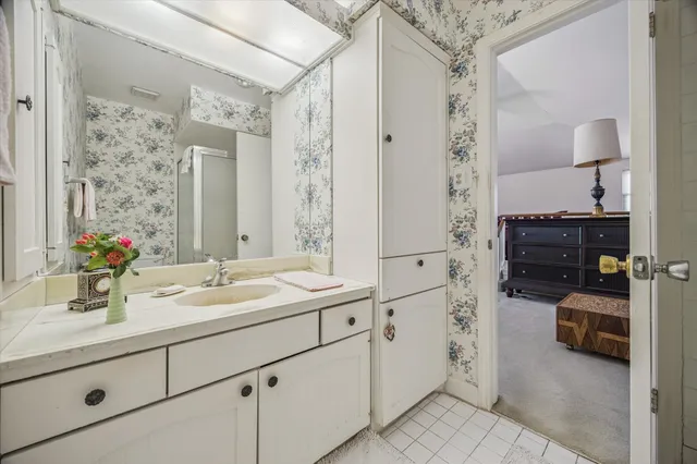 a en suite bathroom with double sink and a mirror