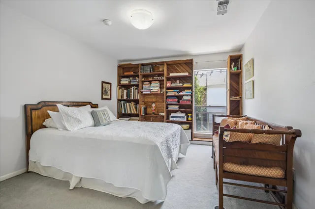 a bed room with a bed and a book shelf