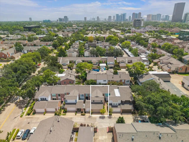 an aerial view of residential houses with city view
