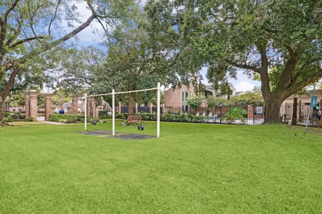 a view of a park with plants and large trees