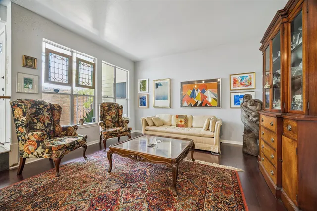 a living room with furniture and a floor to ceiling window