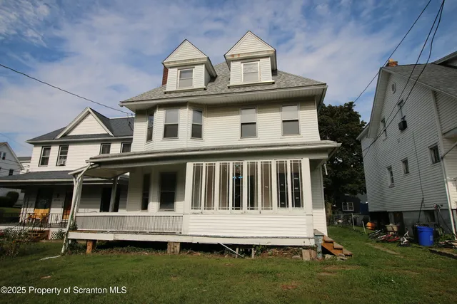 a front view of a house with a garden and yard