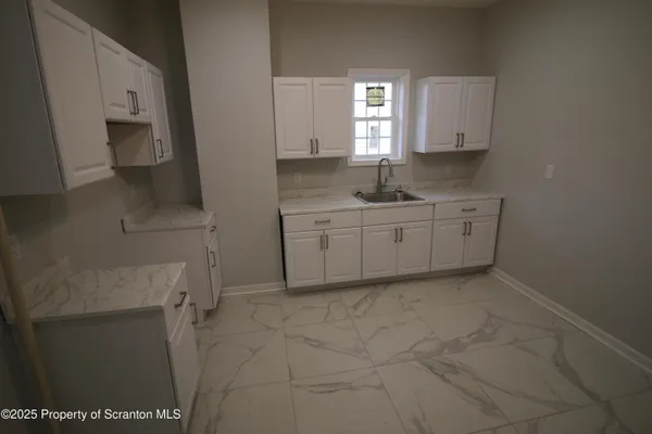 a kitchen with a sink and cabinets