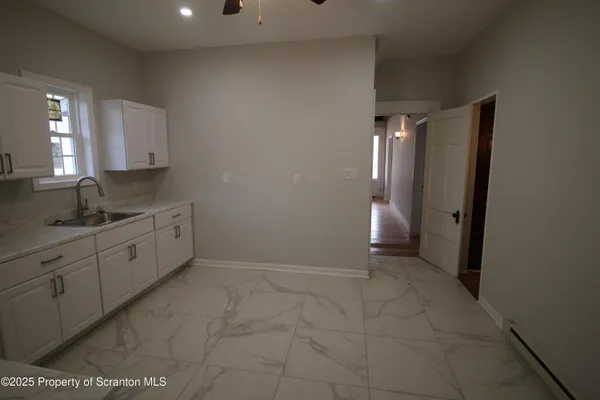 a view of a kitchen cabinets and white appliances