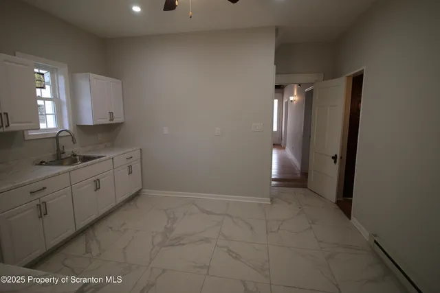 a view of a kitchen cabinets and white appliances