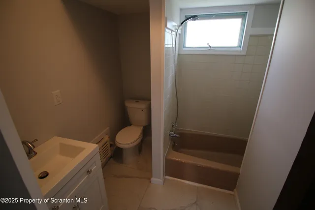 a bathroom with a toilet and a sink