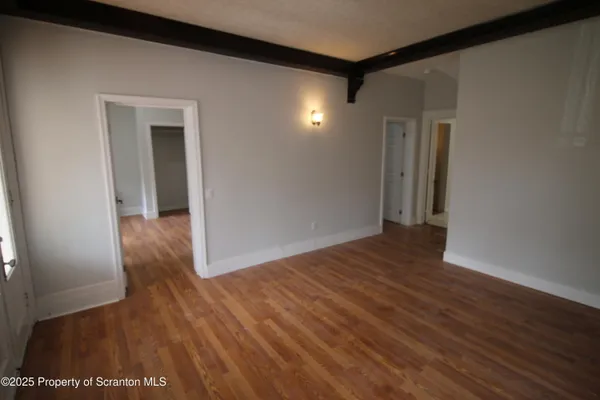 a view of hallway with wooden floor