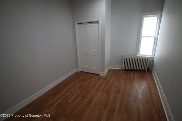 an empty room with wooden floor