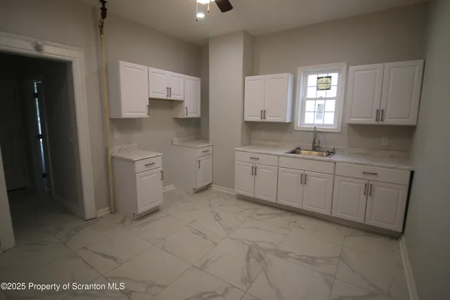 a kitchen with a sink stove and cabinets
