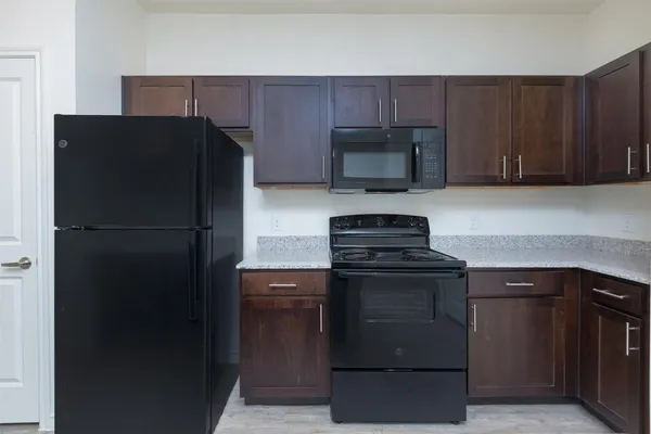 a kitchen with a refrigerator stove and microwave