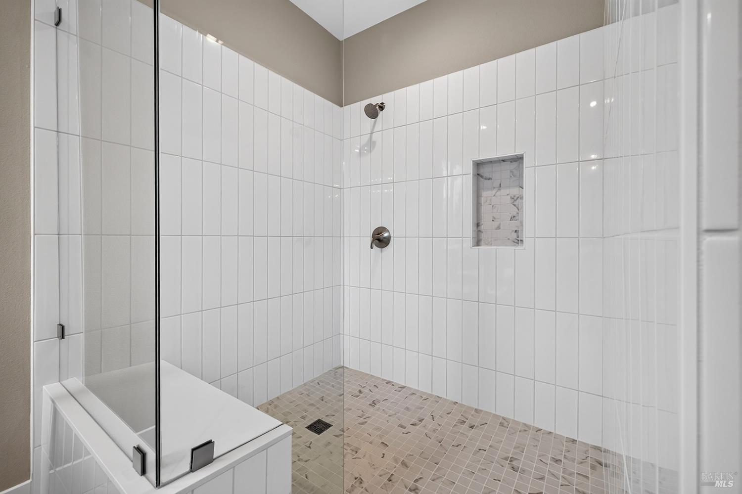 1913 Carlile Place Santa Rosa, CA 95403 - Photo 39 of 60 Here is the view of the large curb less stall shower in the upper-level primary bathroom. The water closet is located to the right of this photo. Look at the beautiful tiled floor and walls.