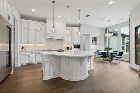 a kitchen with counter space and chairs in it