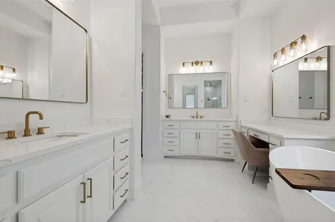a spacious bathroom with a granite countertop sink and a mirror