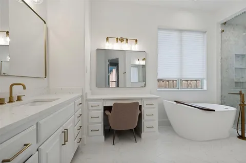 a bathroom with a bathtub a sink and a window