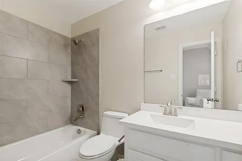 a bathroom with a sink toilet vanity and shower