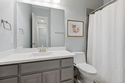 a bathroom with a sink a toilet and a mirror
