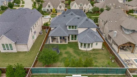 an aerial view of residential houses with outdoor space and parking