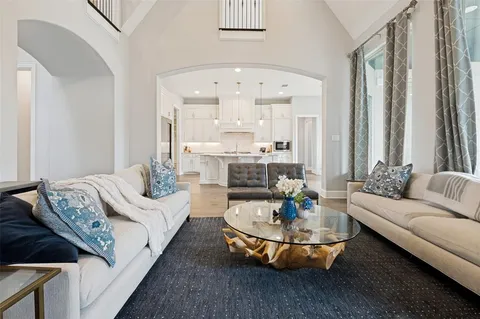 a living room with furniture and a chandelier
