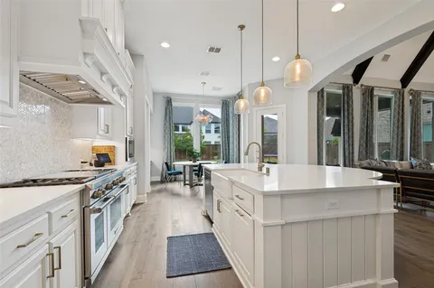 a large white kitchen with lots of counter space