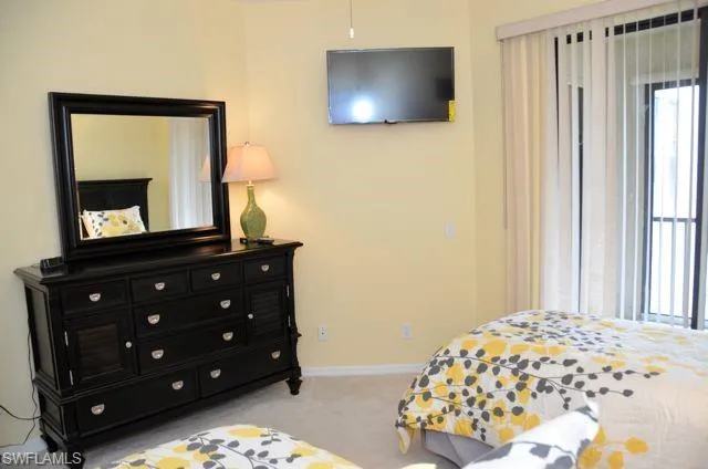 a bedroom with a bed and a mirror on dresser