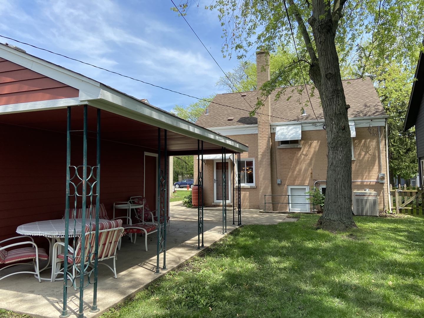 3810 Wolf Road Western Springs, IL 60558 - Photo 33 of 35 a view of a backyard with table and chairs and a large tree