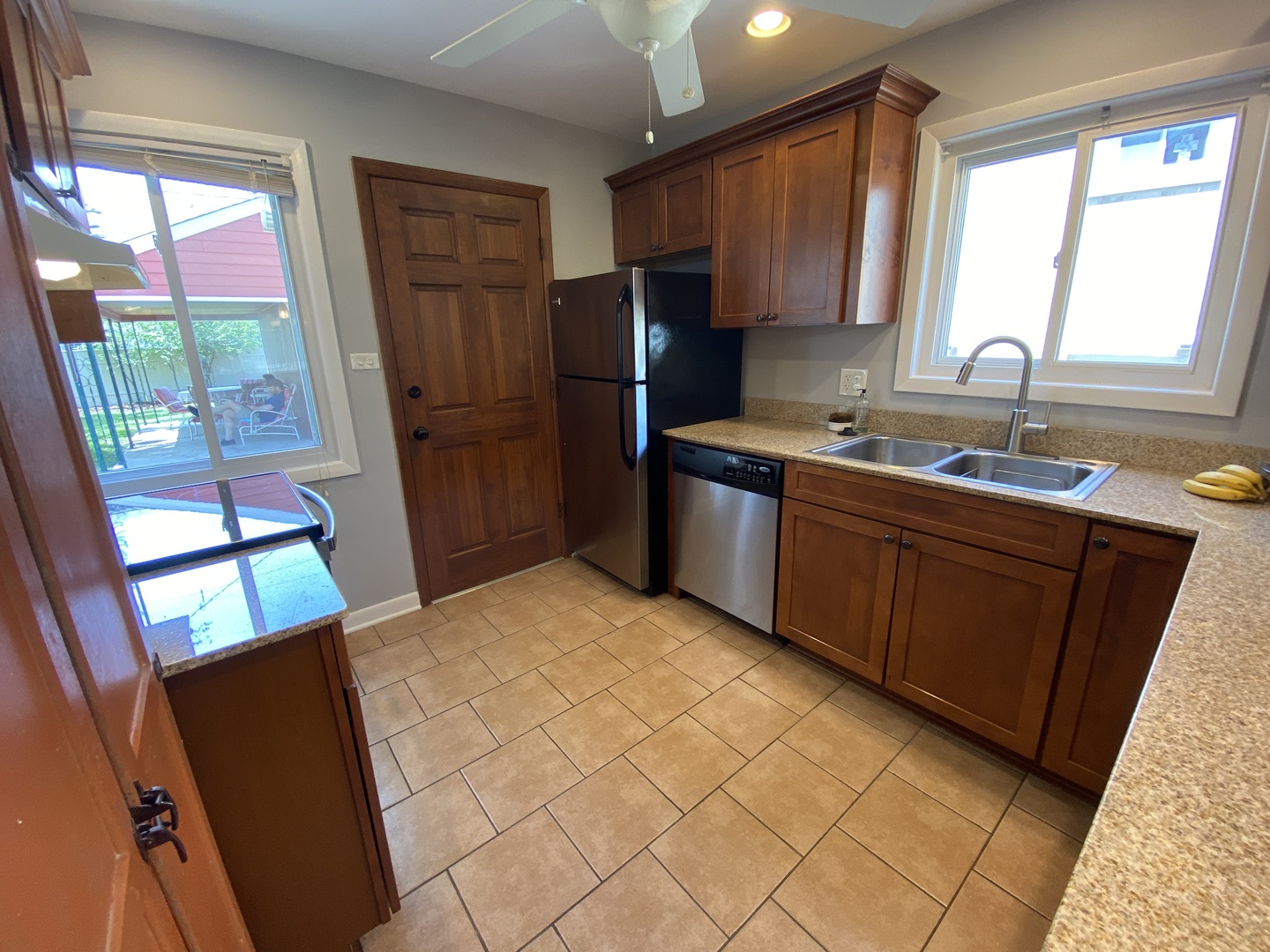 3810 Wolf Road Western Springs, IL 60558 - Photo 9 of 35 a kitchen with stainless steel appliances granite countertop a refrigerator sink and wooden cabinets