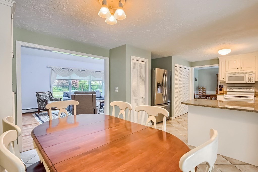 71 Peach Tree Road Barnstable, MA 02648 - Photo 17 of 39 a living room with furniture a large window and a dining table