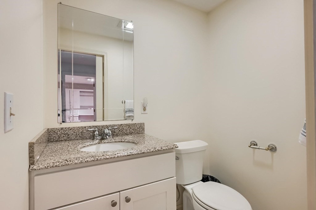 71 Peach Tree Road Barnstable, MA 02648 - Photo 29 of 39 a bathroom with a granite countertop toilet sink and mirror