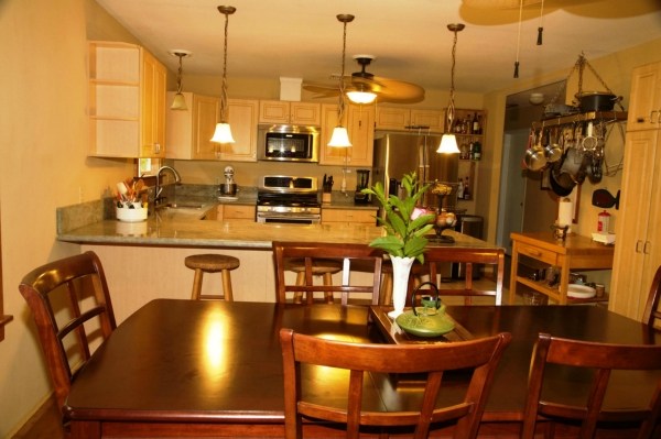 6701 Puupilo Road, Unit A Kapaa, HI 96746 - Photo 1 of 7 a view of a dining room with furniture one side and wooden floor