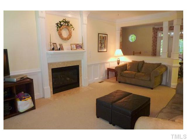 9405 Stone Mountain Road Raleigh, NC 27613 - Photo 2 of 12 Freshly painted family room with gas log fireplace and beautiful moldings.