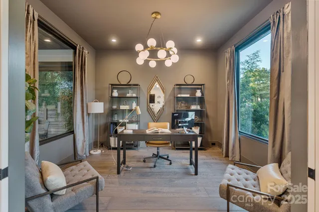 a view of a livingroom with furniture and a large window