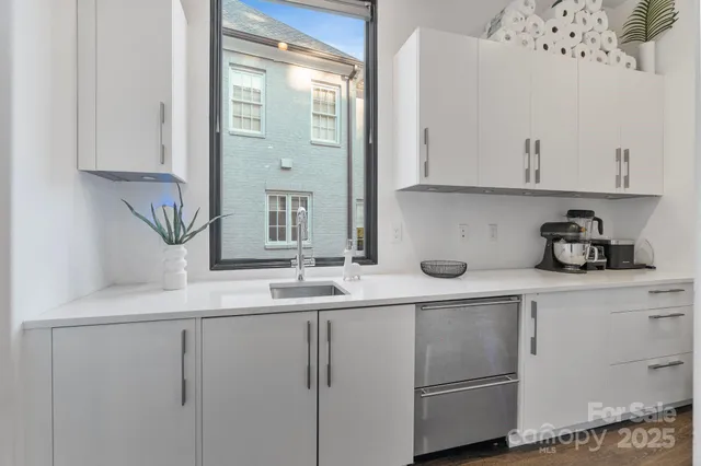 a kitchen with cabinets and window