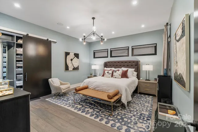 a bedroom with a bed and a chandelier