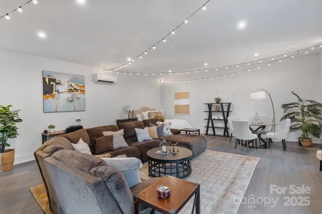 a backyard of a house with table and chairs under an umbrella