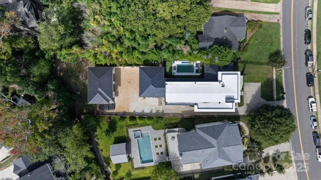 an aerial view of a city with lots of residential buildings ocean and mountain view in back