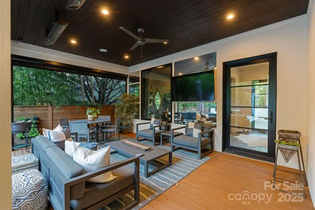 a living room with patio furniture and a floor to ceiling window