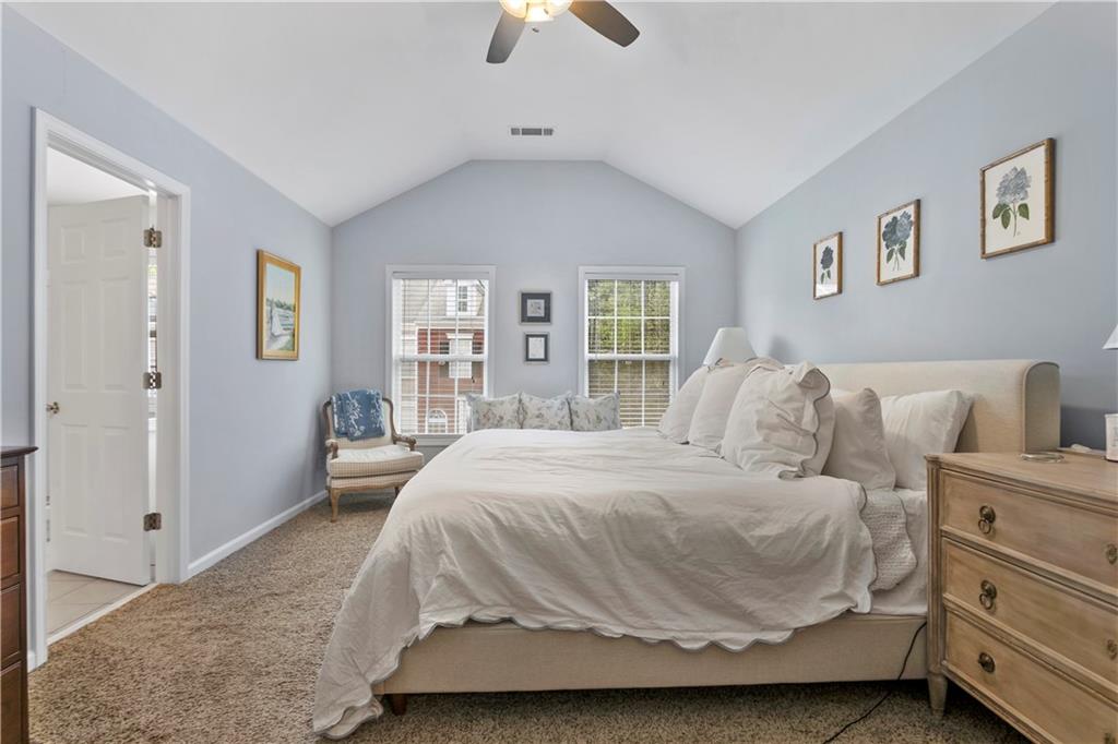 2924 Wintercrest Way Atlanta, GA 30360 - Photo 12 of 36 a spacious bedroom with a bed and a chandelier