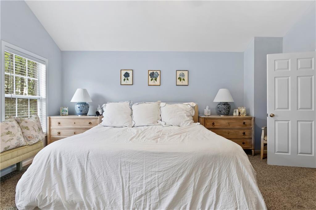 2924 Wintercrest Way Atlanta, GA 30360 - Photo 13 of 36 a bedroom with a large bed and wooden floor