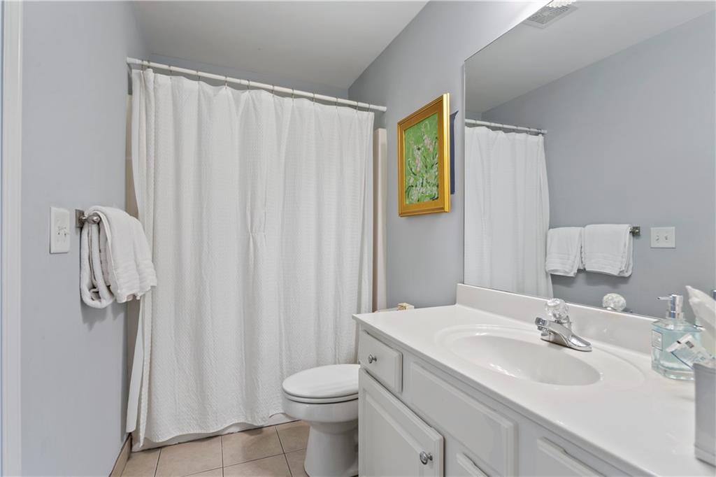 2924 Wintercrest Way Atlanta, GA 30360 - Photo 23 of 36 a bathroom with a sink a toilet and shower curtain