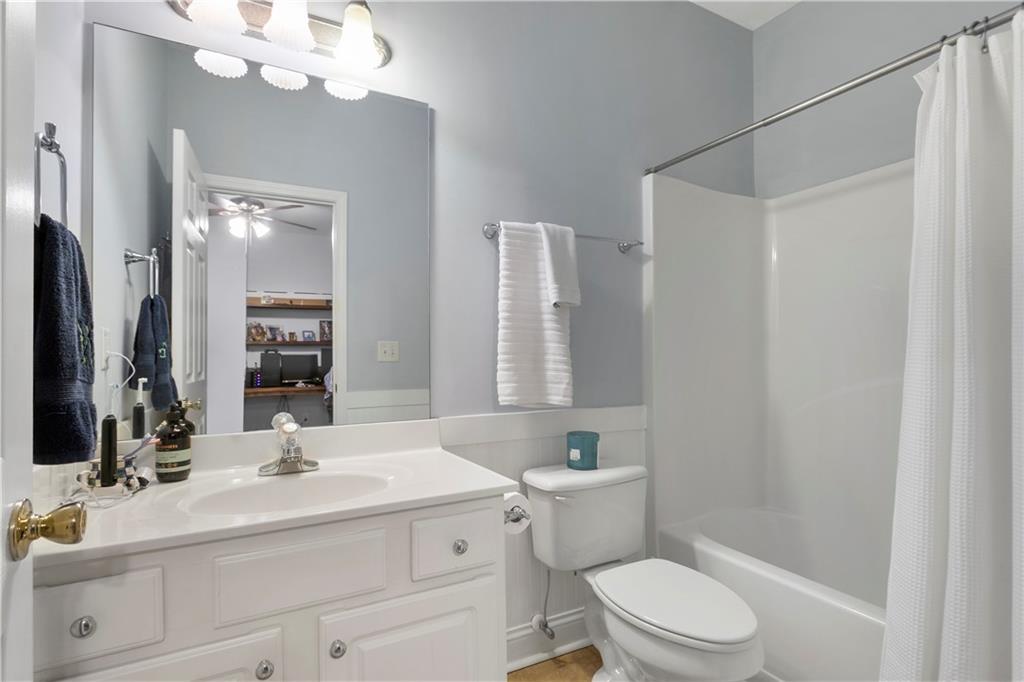 2924 Wintercrest Way Atlanta, GA 30360 - Photo 27 of 36 a bathroom with a sink a toilet a mirror a vanity and shower