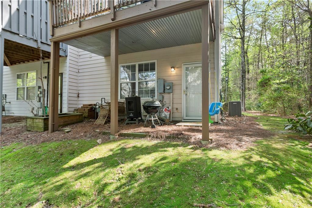 2924 Wintercrest Way Atlanta, GA 30360 - Photo 31 of 36 a view of a backyard with table and chairs and a large tree