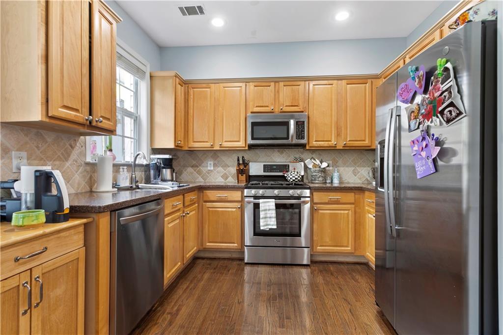 2924 Wintercrest Way Atlanta, GA 30360 - Photo 7 of 36 a kitchen with stainless steel appliances a stove a sink a refrigerator cabinets and a window