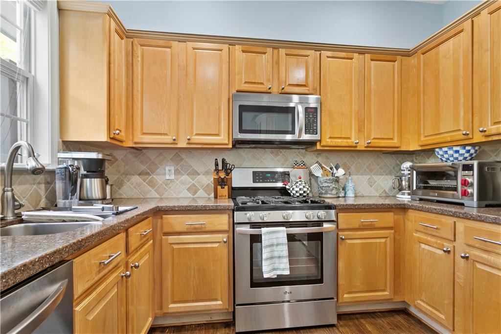 2924 Wintercrest Way Atlanta, GA 30360 - Photo 9 of 36 a kitchen with stainless steel appliances granite countertop a sink a stove and cabinets