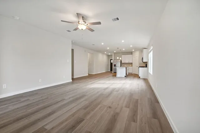 a view of a kitchen with a sink wooden floor and a window