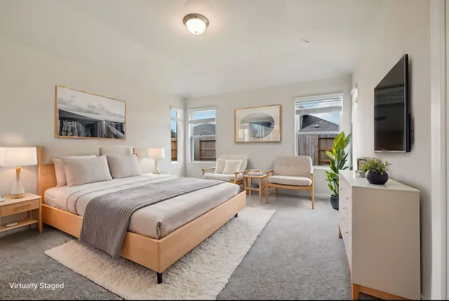 a spacious bedroom with a bed and a couch