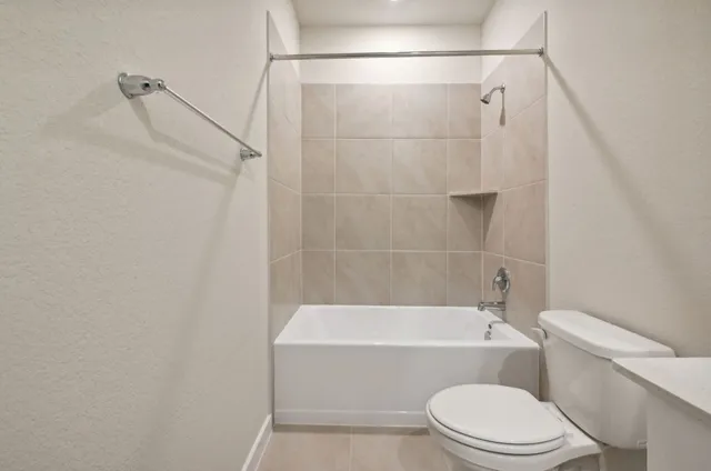a bathroom with a toilet and a bath tub