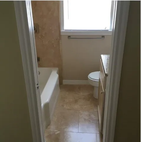 a bathroom with a toilet and a shower