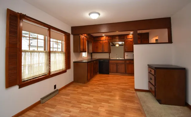 a large kitchen with stainless steel appliances granite countertop a refrigerator and a stove