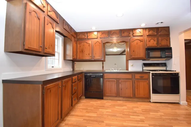 a kitchen with stainless steel appliances granite countertop a sink and cabinets