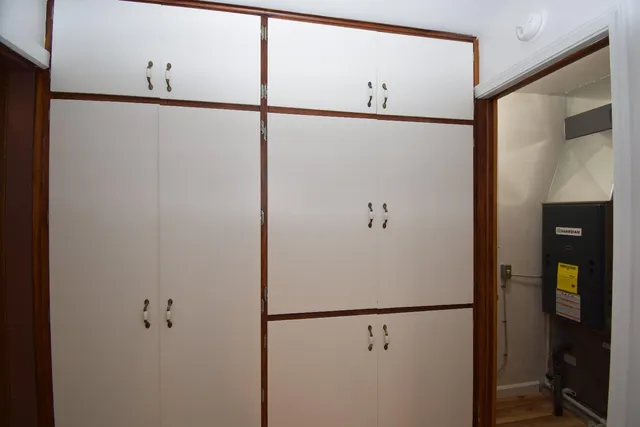 a white refrigerator freezer and white cabinets